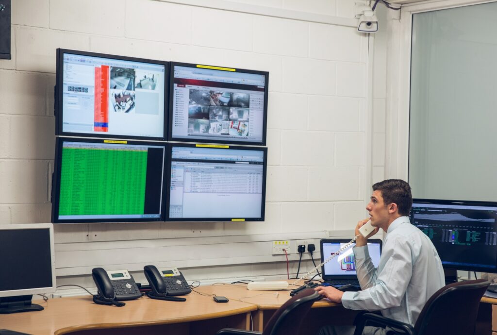 Technician sitting in office running diagnostics in large data center