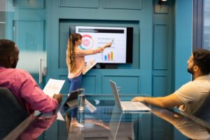 presenting-department-budget-woman-pointing-screen-meeting-with-colleagues