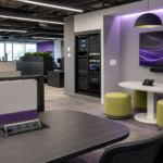 Modern office space with AV connection ports, equipment rack, display screen, and integrated connectivity infrastructure for Covid AV solutions.