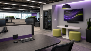 Modern office space with AV connection ports, equipment rack, display screen, and integrated connectivity infrastructure for Covid AV solutions.