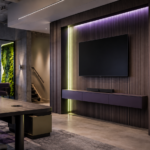 Modern AV room with organized cable management, table connection ports, equipment rack, and display technology for professional AV systems.