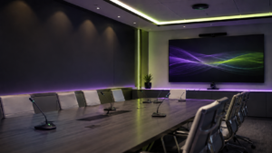 Modern conference room with integrated microphones and display screen for professional Shure audio and AV conferencing solutions.